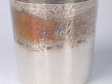an image of a silver cup on a white surface with a white background