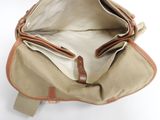 the inside of a tan and brown bag with a brown handle