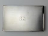 an antique silver cigarette case with a monogram on the front