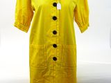 the dress is yellow and has black buttons on it