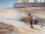 two people walking on the beach with their luggage