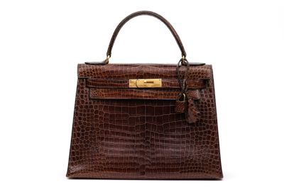 a brown crocodile skin handbag on a white background