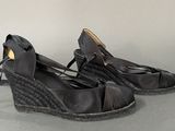 a pair of black shoes that are on a table