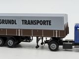 a toy truck with a trailer on the back of it