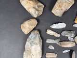 several pieces of rock and stone sitting on a black surface