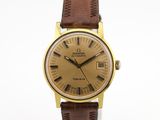 une photo d'une montre en or avec un bracelet en cuir marron