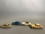 several toy cars are lined up in a row on a gray surface