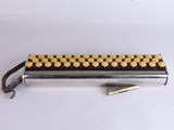 a close up of a metal object with yellow dots on it