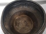 a metal bowl that is sitting on a table