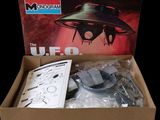 a box with a model of an alien ship in it