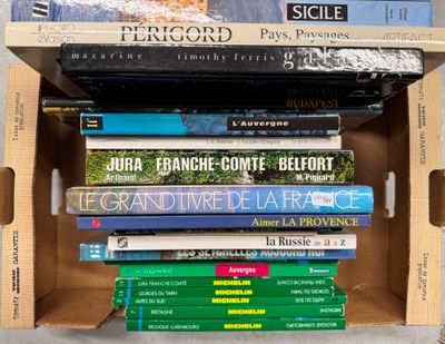 many books stacked on top of each other in a box