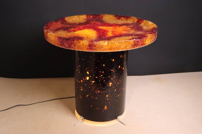 a table with a lamp on top of it on a table