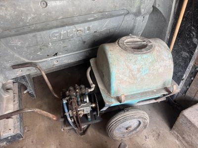 a machine that is sitting on the ground next to a car