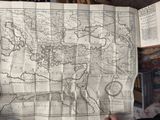 someone is holding a map of the world in their hands