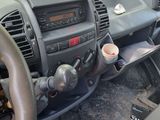 a picture of a car dashboard with a cup in it