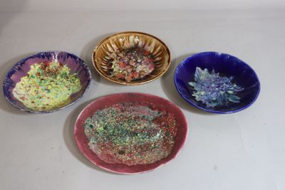 four bowls of different colors and designs on the table