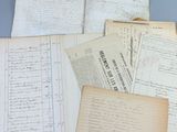 several old papers are stacked on top of each other on a table