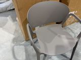 a stack of boxes and a chair on the floor