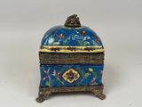 a blue and gold box with a bird design on it