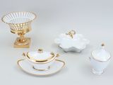 a white and gold table setting with a bowl, saucer, cup, and saucer