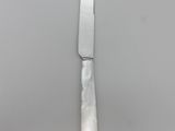 an image of a knife on a plate on a table