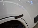 a close up of a white truck with a sticker on it