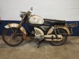 a old motorcycle that is parked in a garage
