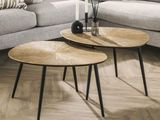 two tables that are sitting on the floor in the living room