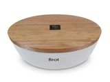 a close up of a white bowl with a wooden lid