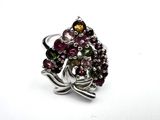 a close up of a ring on a white surface with a flower design