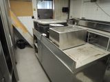 a picture of a commercial kitchen with stainless steel appliances