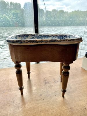 a wooden table with a blue and white bowl on it