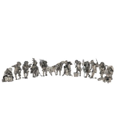 a group of silver figurines of people and animals on a white background