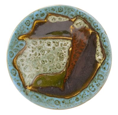 a blue plate with a brown and green design on it