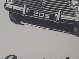 a black and white image of a car with a man in the back seat