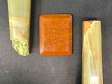 three pieces of yellow jade on a black surface