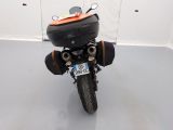 a motorcycle parked in a room with a helmet on the back of it