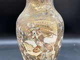 un vase avec un tableau posé sur une table