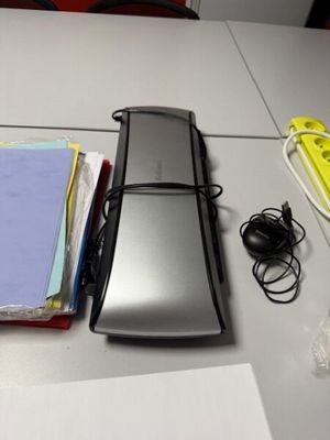 an image of a desk with a cell phone and other office supplies
