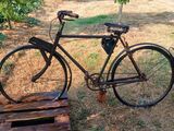 a bike that is parked next to a wooden pallet