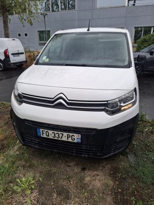 the white van is parked on the side of the road in front of a building