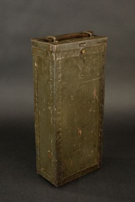 an old green metal box with a handle on a black background