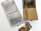 two small metal tins are sitting next to each other on a white surface