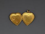 two gold heart lockes, one with a lock and the other with a key