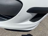 a close up of a white car ' s front bumper