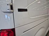 a close up of a white van with a red tail light