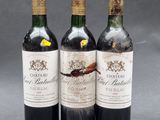 three bottles of wine sitting on top of a table next to each other