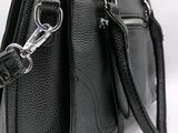 black leather handbag with silver hardware on a white background