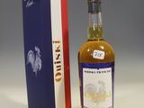 a bottle of whisky next to a box on a table