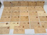 many old letters and envelopes laid out on a table